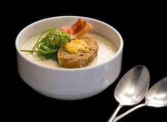 Soup puree, cream soup yellow with ham and croutons, dry bread. close up