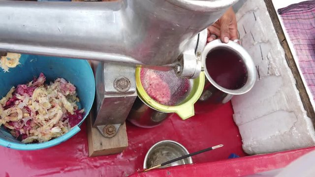 Street food- Fresh fruits juice being sold and served of sweet lemon or mausami, orange or santra, anaar or pomegranate by vendor cart in the hot weather. 4k slow-motion close-up stabilized handheld