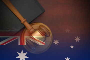 Law concept, gavel and legal book on wooden table, collage with flag of Australia