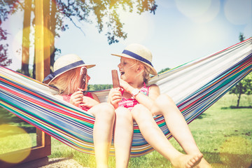 girls in hammock eating ice cream