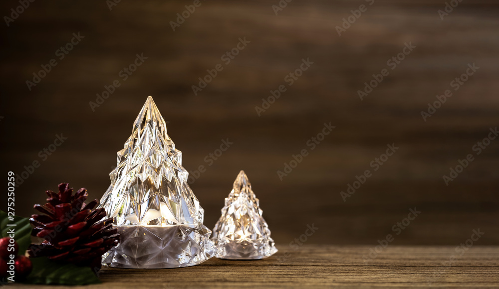 Poster modern glass christmas tree with lights on dark wood table with wall for merry chirstmas and new yea