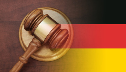 Judge gavel on wooden table, collage with German flag