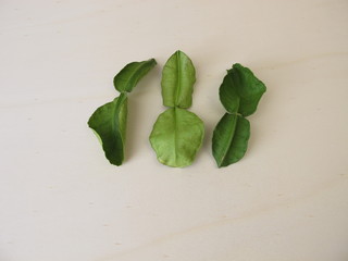 Dried kaffir lime leaves on a wooden board