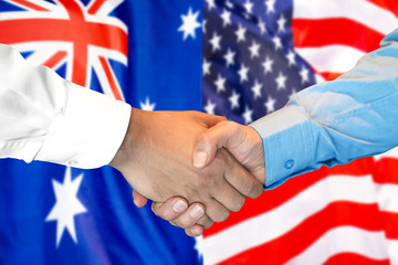 Business handshake on the background of two flags. Men handshake on the background of the Australia and United States of America flag. Support concept