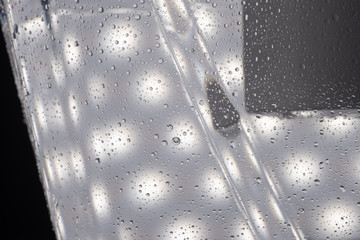 Macro photography of water drops flowing down the cold plastic carafe for water purification