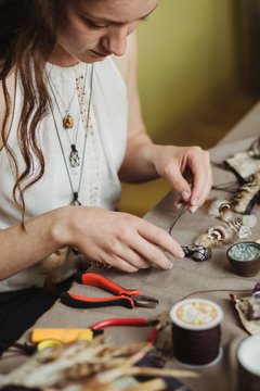 Artisan woman making handmade gemstone jewelry