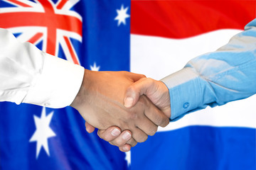 Business handshake on the background of two flags. Men handshake on the background of the Australia and Dutch flag. Support concept
