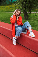 Chherful attractive young girl wearing raincoat