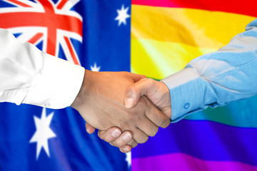 Business handshake on the background of two flags. Men handshake on the background of the Australia and LGBT gay flag. Support concept