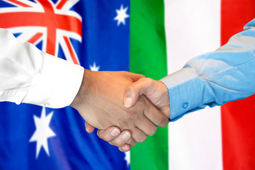 Business handshake on the background of two flags. Men handshake on the background of the Australia and Italy flag. Support concept