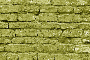 Old grungy brick wall texture in yellow tone.