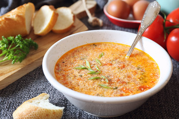Italian food. Stracciatella tomato soup: parsley, eggs and parmesan cheese