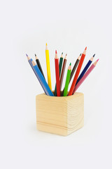 Fototapeta premium colorful pencils for drawing in a wooden cube
