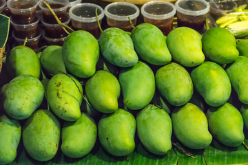 Fresh Fruit Green Mangoes with Sauce Dip on Shelf in Fresh Fruit market Thailand Travel Background Concept