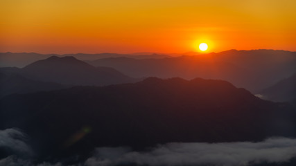 Panorama photo of beautiful sunrise and layers of mountains view from camping spot at Doi pui ko, Mae hong son, Thailand.