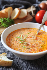 Italian food. Stracciatella tomato soup: parsley, eggs and parmesan cheese