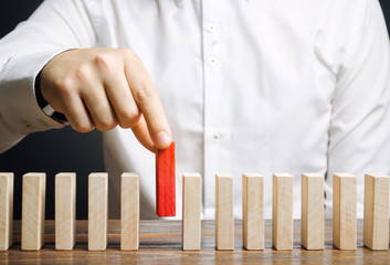 Businessman holds a wooden block in his hands. The concept of personnel selection and management...