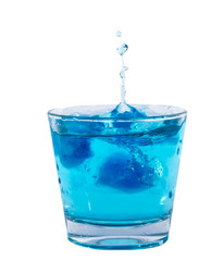 Blue ice cubes splashing into glass of water.