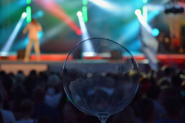 Scene with light rays in the evening and the audience. Concert