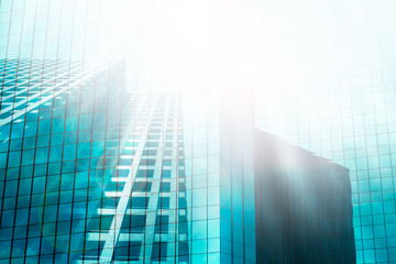 Fototapeta na wymiar Light blue skyscraper reflection background with sun reflect and flare. building business concept.
