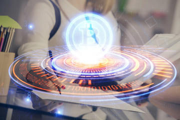 Cryptocurrency hologram over woman's hands writing background. Concept of blockchain. Double exposure