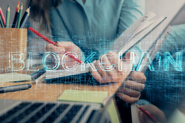 Cryptocurrency hologram over woman's hands writing background. Concept of blockchain. Multi exposure
