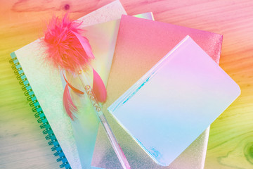 Texture of books and notebooks with a colorful haze.