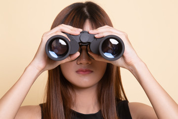 Young Asian woman with binoculars.