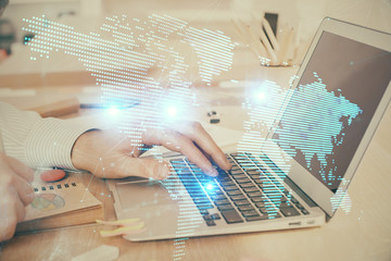 Social network theme hologram with businessman working on computer on background. Concept of world...