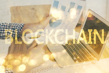 Crypto currency theme hologram with businessman working on computer on background. Concept of...