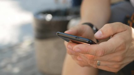 hands manager guy in a white shirt are typing a text message on a mobile phone