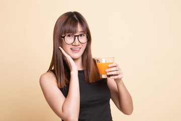 Happy Young Asian woman drink orange juice.