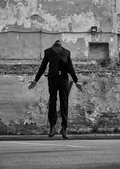Depressed lonely man jumping and wanting to fly and travel from problem. Business concept of free....