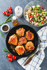 Delicious fried chicken thighs in a cast iron skillet