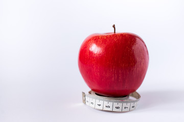 red apple with measuring tape isolated on white