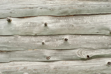 Old distorted boards in a row on the wall. Texture of natural rough boards.