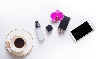 cup of coffee with smart  phone and lady care set around white background. life style flat lay