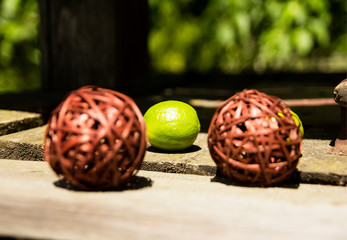 Ball of wood. With lime fruit. With place for calligraphy.