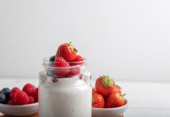 yogurt with fruit on a breakfast table on a white background
