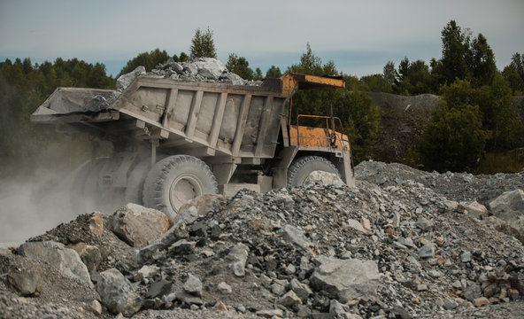 yellow truck. loaded with coal. sunny weather. kamaz bears a white breed. coal mine. extract cement 