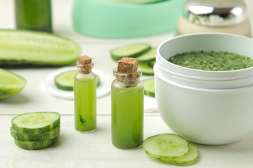 Obraz na płótnie Canvas Face mask with cucumber. Cosmetics with cucumber extract on a white wooden table. spa. beauty.