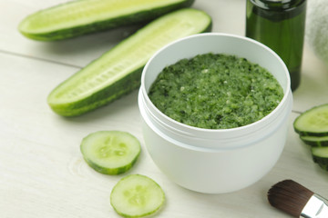 Face mask with cucumber. Cosmetics with cucumber extract on a white wooden table. spa. beauty.