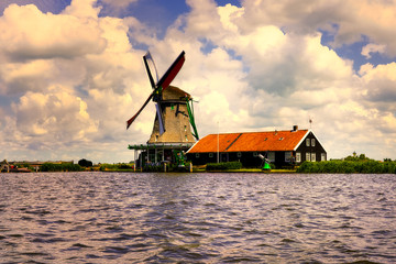 Naklejka premium The famous Zaanse Schans mills in Zaandam, on the Zaan river. Famous holland attraction, windmills.