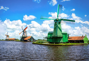 Naklejka premium The famous Zaanse Schans mills in Zaandam, on the Zaan river. Famous holland attraction, windmills.