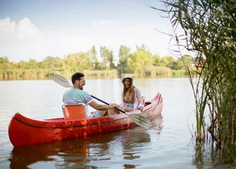 Foto op Canvas Loving couple rowing on the lake © BGStock72