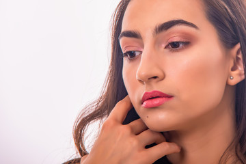 Portrait of Attractive Young Female Model. The girl poses in a studio with a white background.