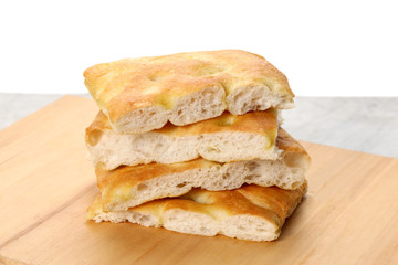 slices of traditional italian focaccia  rest on a wooden cutting board with copy space for your text