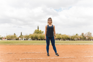 Sporty woman standing on stadium track