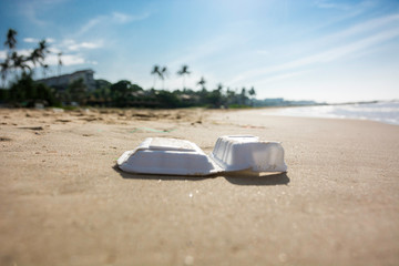 Fototapeta na wymiar Plastic food box trash pollution on the sandy beach in Vietnam