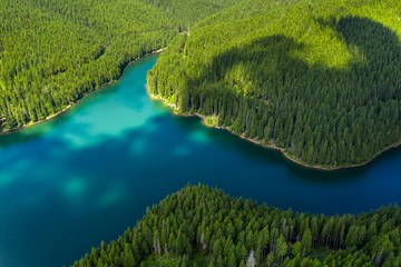 Mountain forest lake landscape. Aerial view. View on the turquoise color lake between mountain...